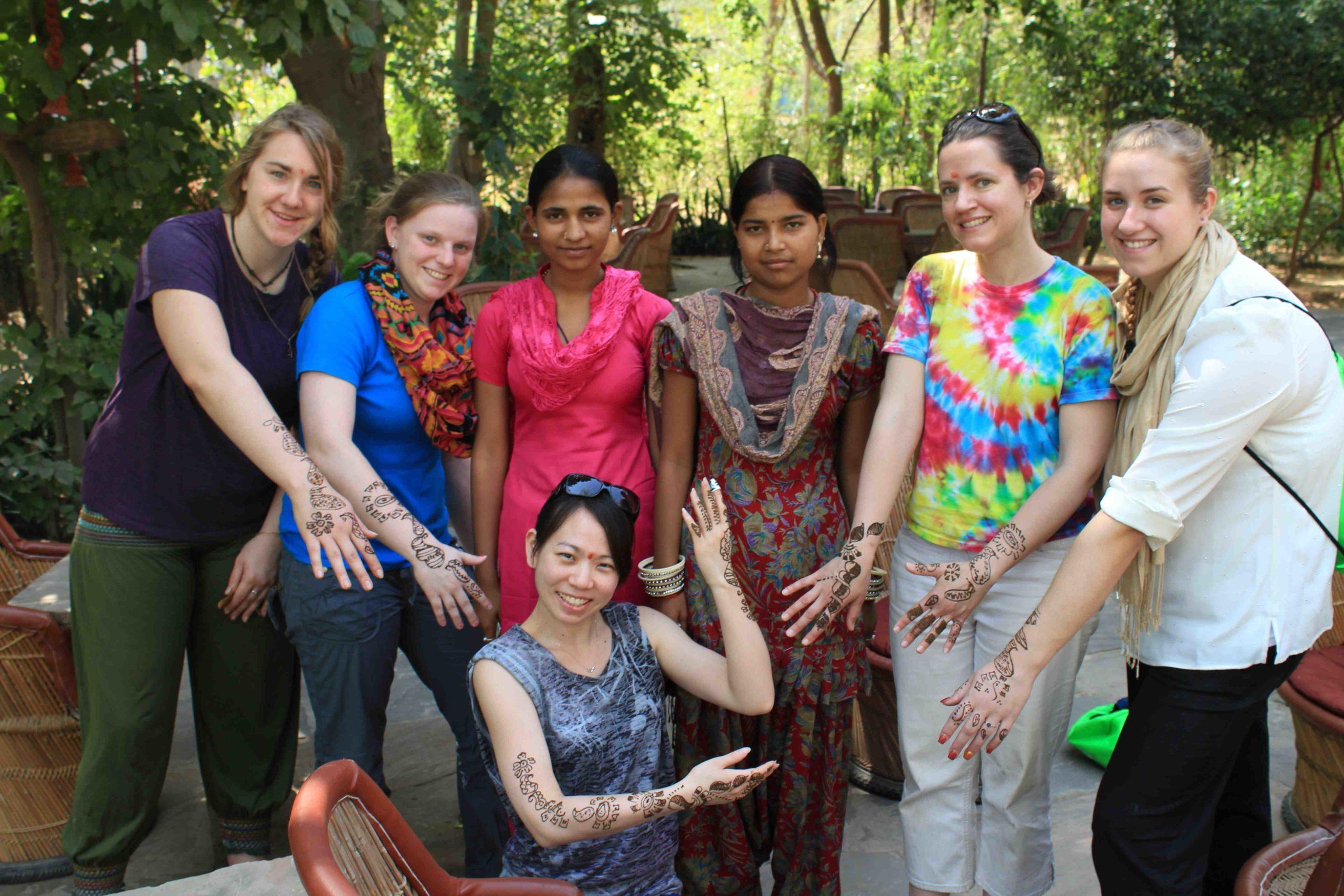 Students show off their henna tattoos during a 研究了 trip to India